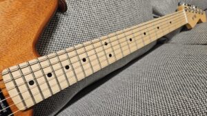 horizontal photograph of RF40 custom partscaster's neck with focus on higher frets