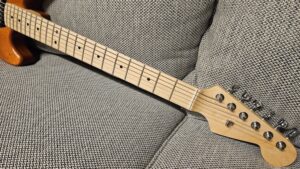 horizontal photograph of RF40 custom partscaster's neck with focus on lower frets and headstock