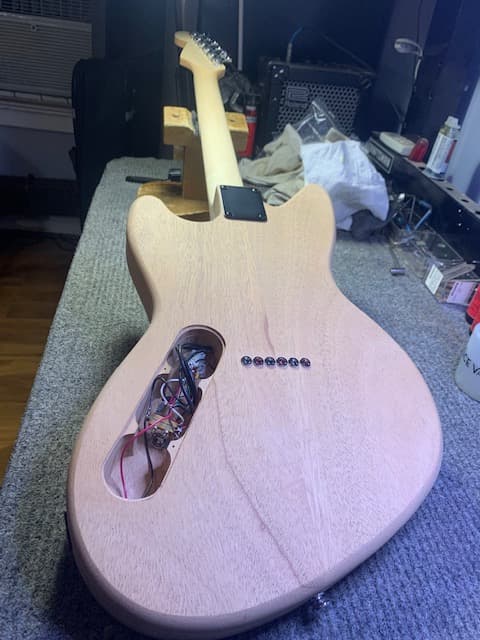 unfinished custom partscaster with the back plate removed showing the wiring