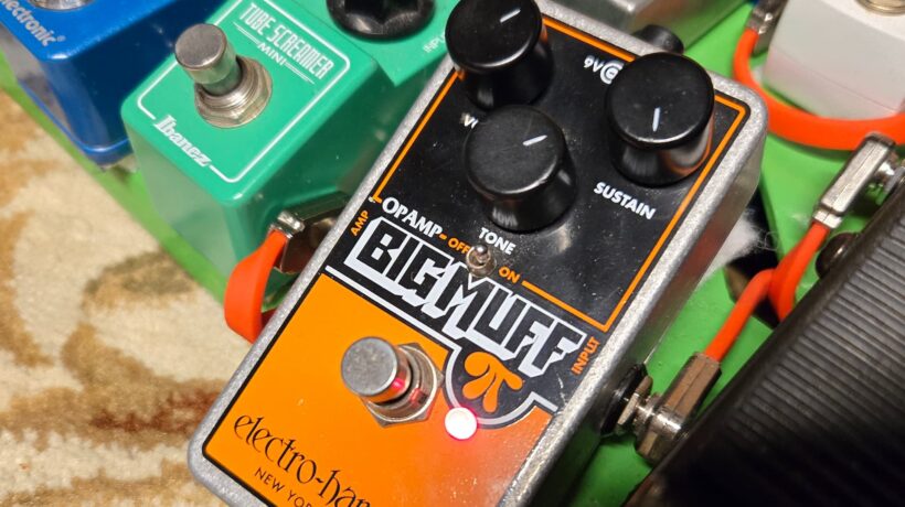 an electro-harmonix op-amp big muff engaged and on a pedalboard